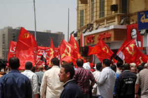 Egyptian workers carrying Communist Party flags in Tahrir square. 