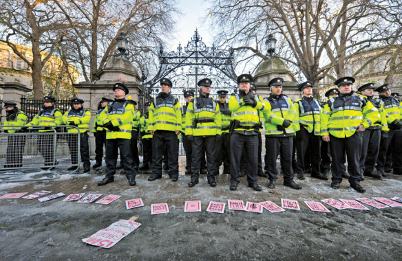 The repressive state apparatus - Photo by Barbara Lindberg / Rex, Features a deck of large cards carrying protest slogans lies spread out on the ground in front of a large police contingent protecting the front gates of Leinster House - Dail Eireann during a splinter group protest. Demonstration to protest Austerity Plan, Dublin, Ireland - 27 Nov 2010
